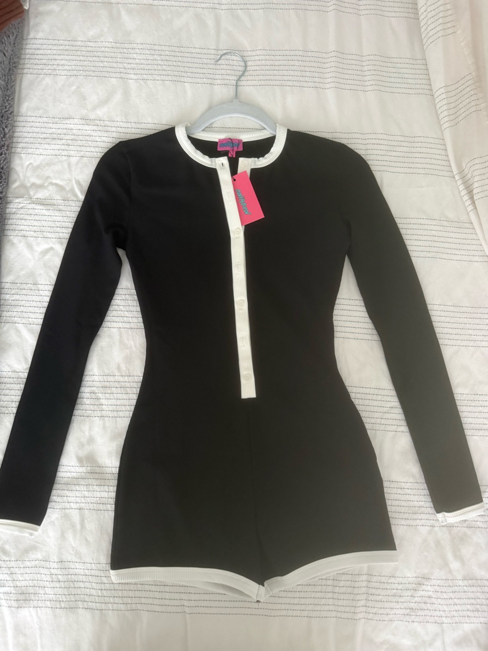 Edikted black long sleeve ribbed shortie romper with off white trim.
